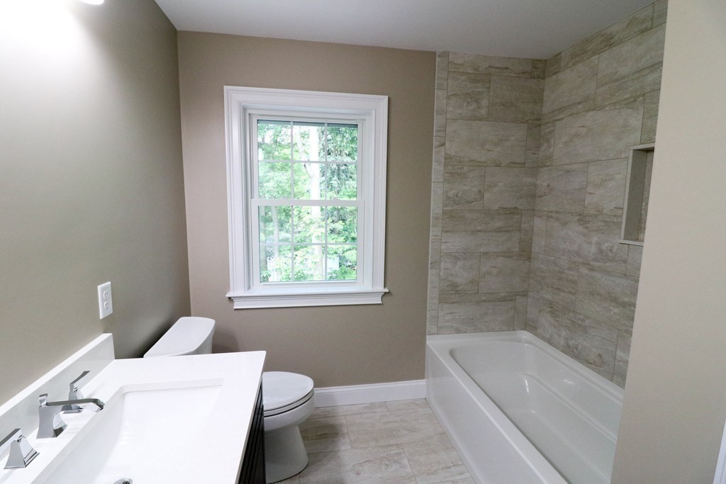 5 West River Street Upton, MA 01568 - Photo 27 of 37 a bathroom with a granite countertop bathtub sink vanity and toilet