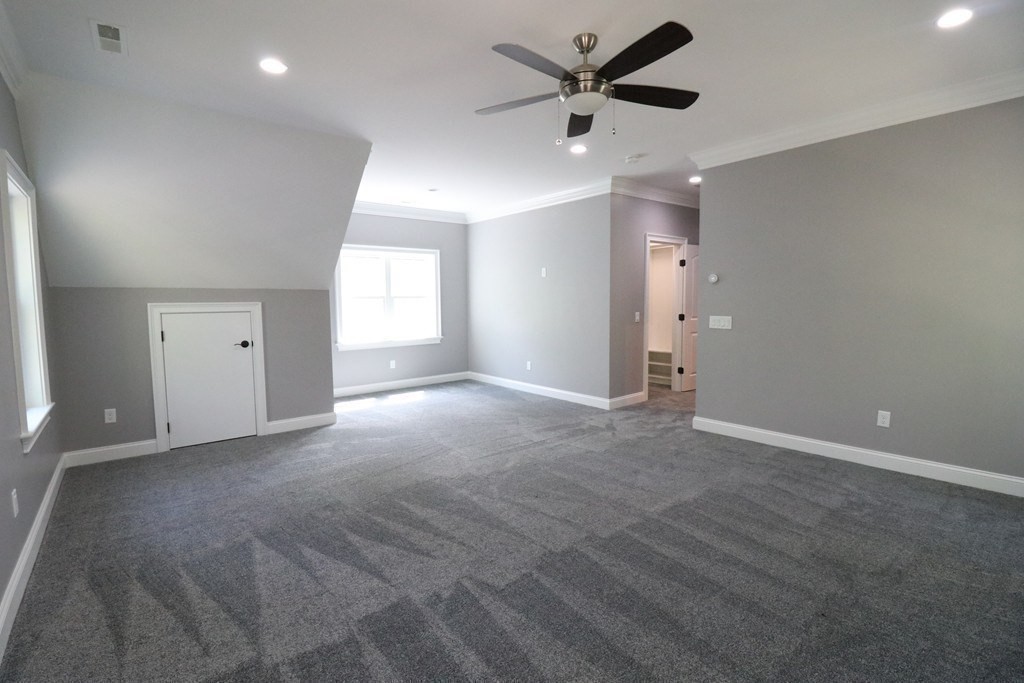 5 West River Street Upton, MA 01568 - Photo 31 of 37 an empty room with ceiling fan and windows