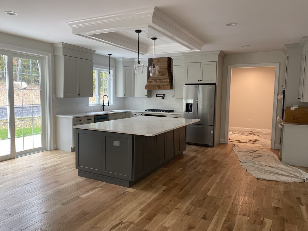 5 West River Street Upton, MA 01568 - Photo 34 of 37 a large kitchen with stainless steel appliances a large counter top a sink a refrigerator and window