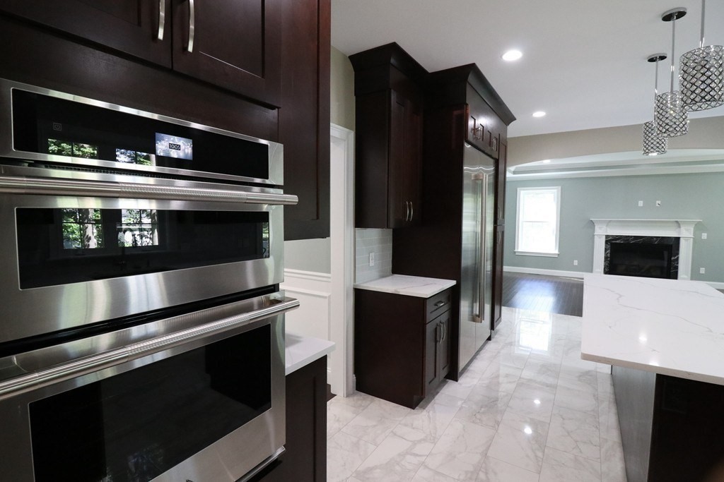 5 West River Street Upton, MA 01568 - Photo 7 of 37 a modern kitchen with stainless steel appliances and stove top oven