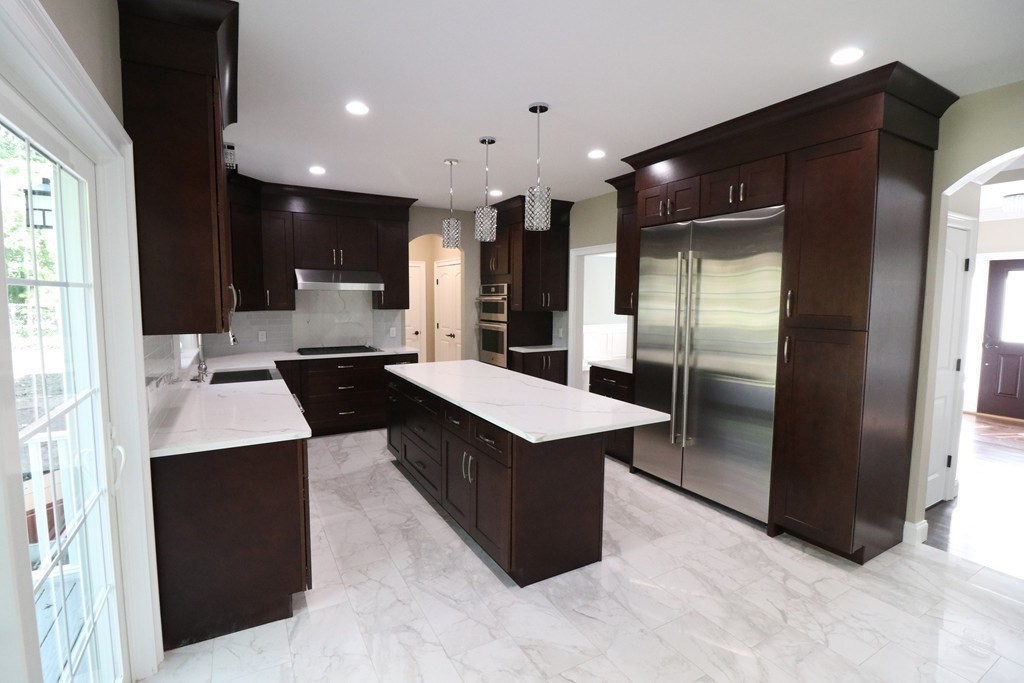 5 West River Street Upton, MA 01568 - Photo 9 of 37 a kitchen with kitchen island stainless steel appliances a sink stove and refrigerator