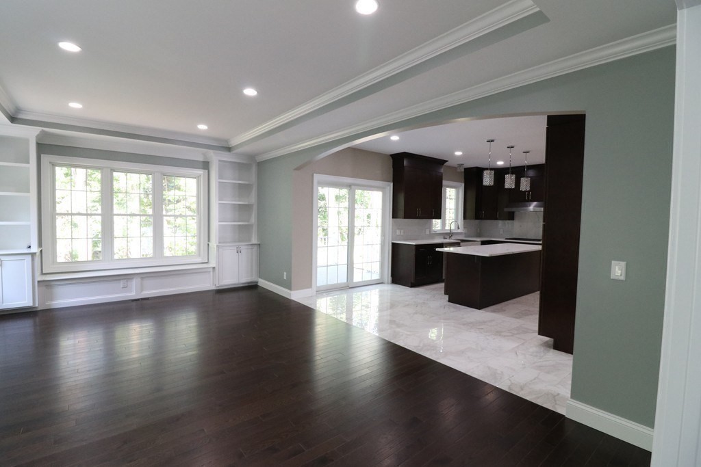 5 West River Street Upton, MA 01568 - Photo 10 of 37 a large kitchen with stainless steel appliances a large counter top a stove and a wooden floors