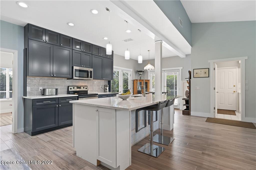 Undisclosed Address Vero Beach, FL 32963 - Photo 11 of 36 a kitchen with stainless steel appliances kitchen island granite countertop a large stove a sink dishwasher and a refrigerator with wooden floor
