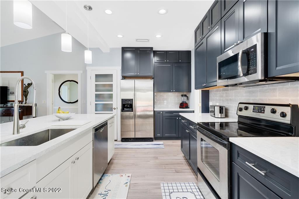 Undisclosed Address Vero Beach, FL 32963 - Photo 12 of 36 a kitchen with stainless steel appliances granite countertop a sink a stove and a refrigerator