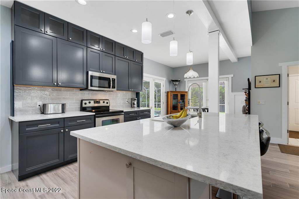 Undisclosed Address Vero Beach, FL 32963 - Photo 16 of 36 a large kitchen with stainless steel appliances and a view of living room