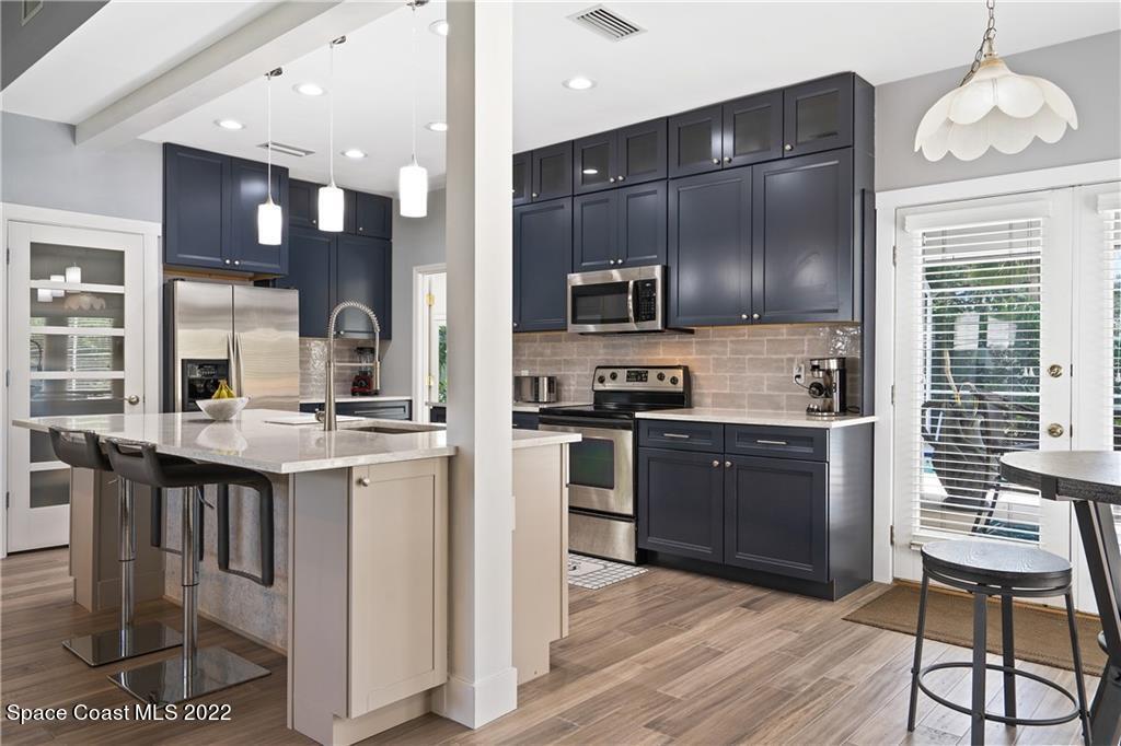 Undisclosed Address Vero Beach, FL 32963 - Photo 17 of 36 a kitchen with granite countertop a stove cabinets and refrigerator