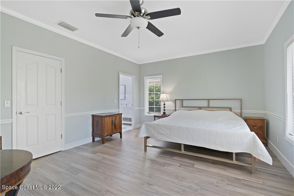 Undisclosed Address Vero Beach, FL 32963 - Photo 22 of 36 a bedroom with a bed and wooden floor
