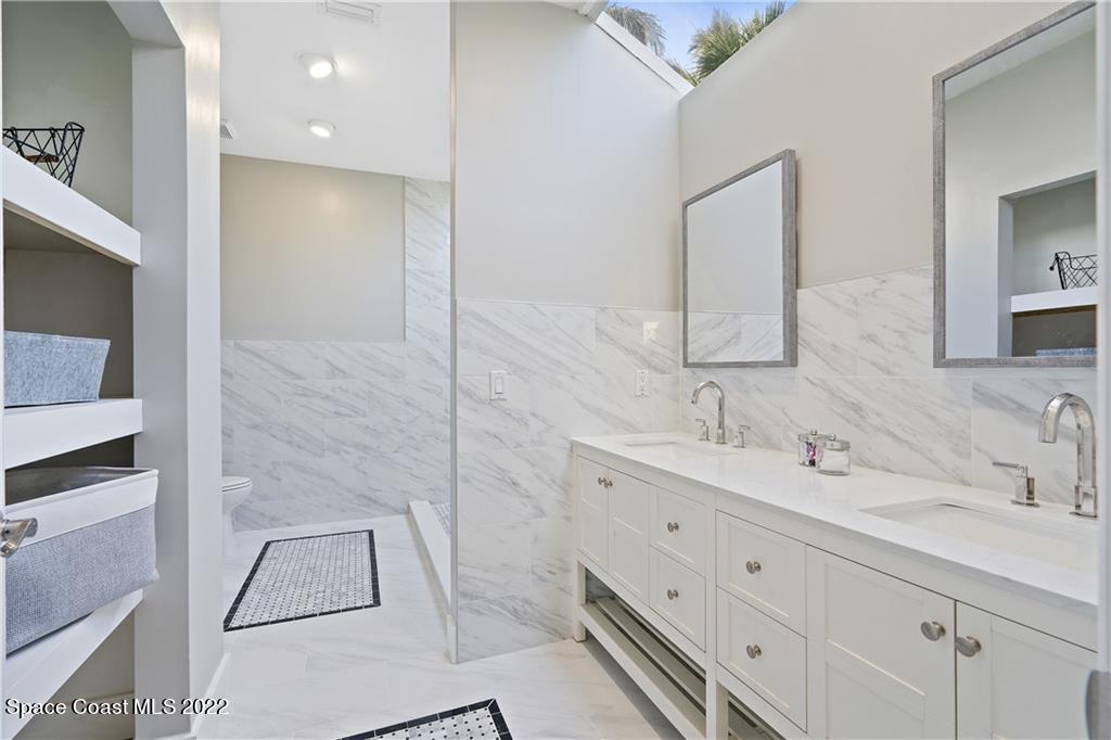 Undisclosed Address Vero Beach, FL 32963 - Photo 23 of 36 a bathroom with a double vanity sink mirror and