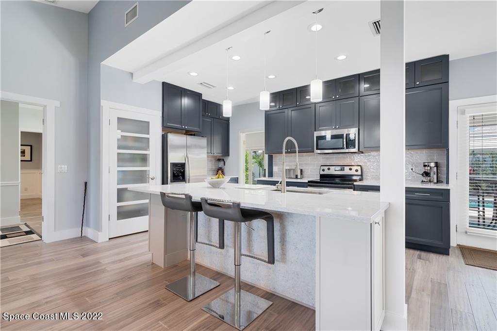 Undisclosed Address Vero Beach, FL 32963 - Photo 10 of 36 a kitchen with stainless steel appliances a sink a stove a refrigerator and cabinets