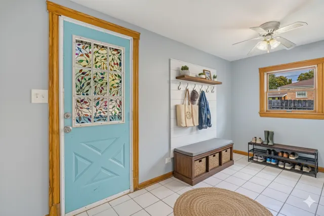 a living room with wall paintings and a window
