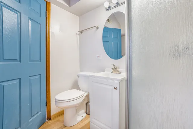 a bathroom with a toilet sink and mirror