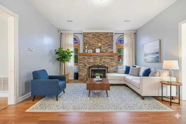 a living room with furniture and a fireplace