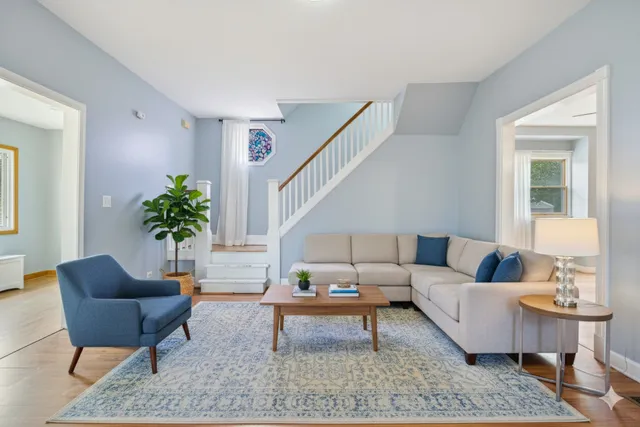 a living room with furniture and a potted plant