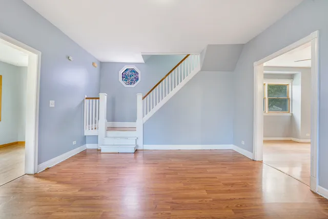 a view of entryway and hall with wooden floor