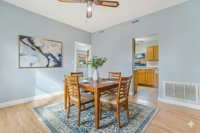 a dining room with furniture and wooden floor
