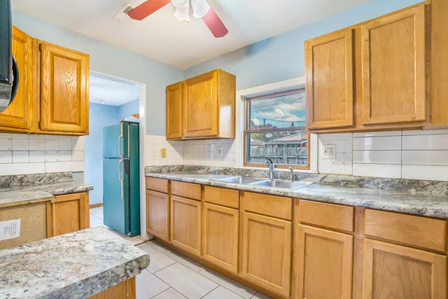 a kitchen with granite countertop cabinets sink and window