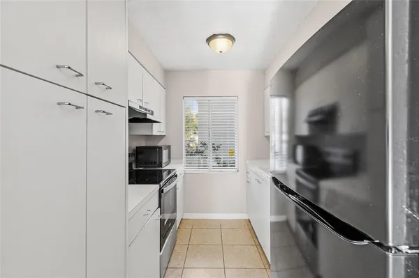 a kitchen with a refrigerator stove and microwave