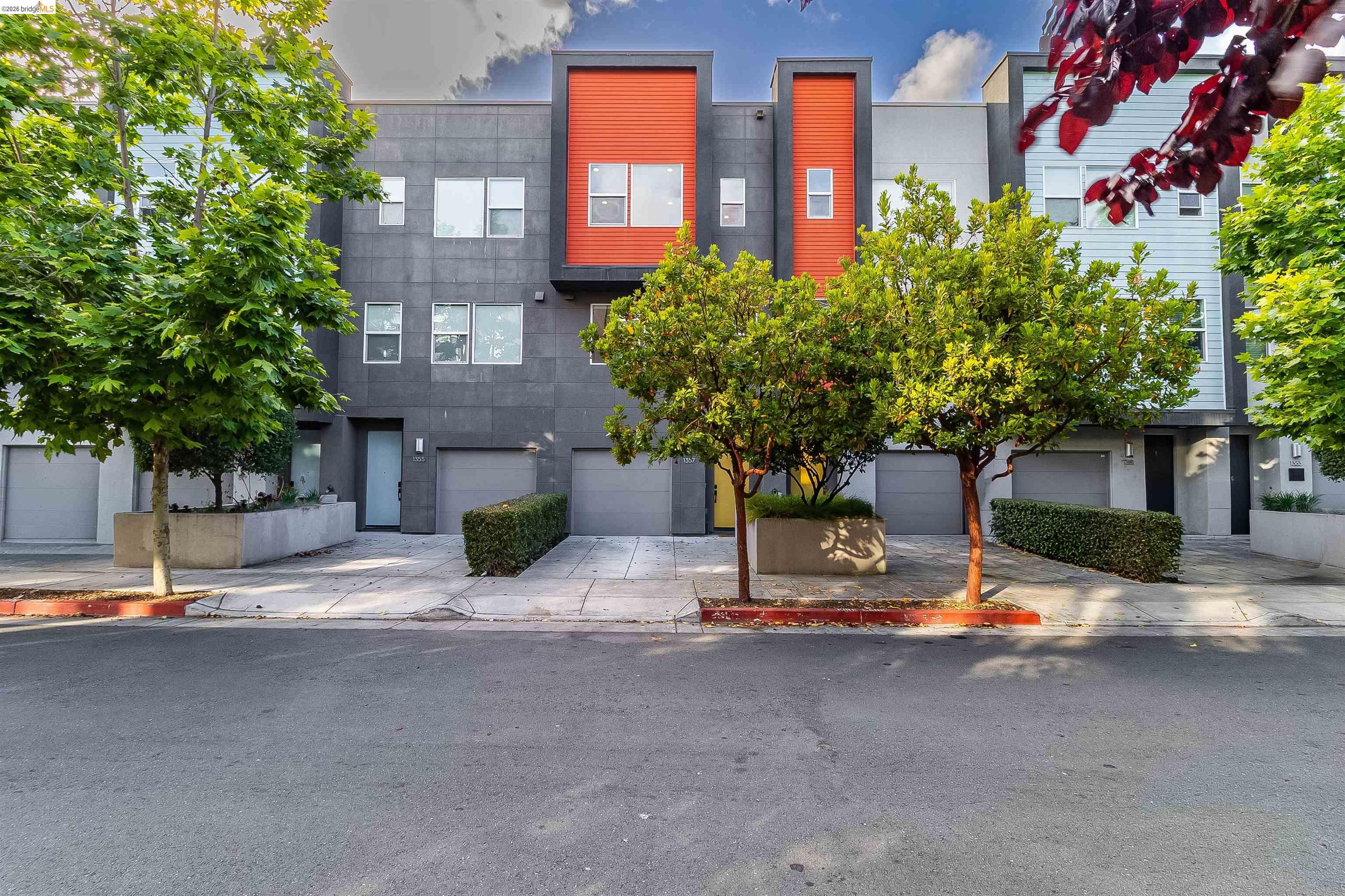 1357 Pullman Way Oakland, CA 94607 - Photo 2 of 37 Modern facade featuring a combination of dark paneling, orange accents, and light blue siding