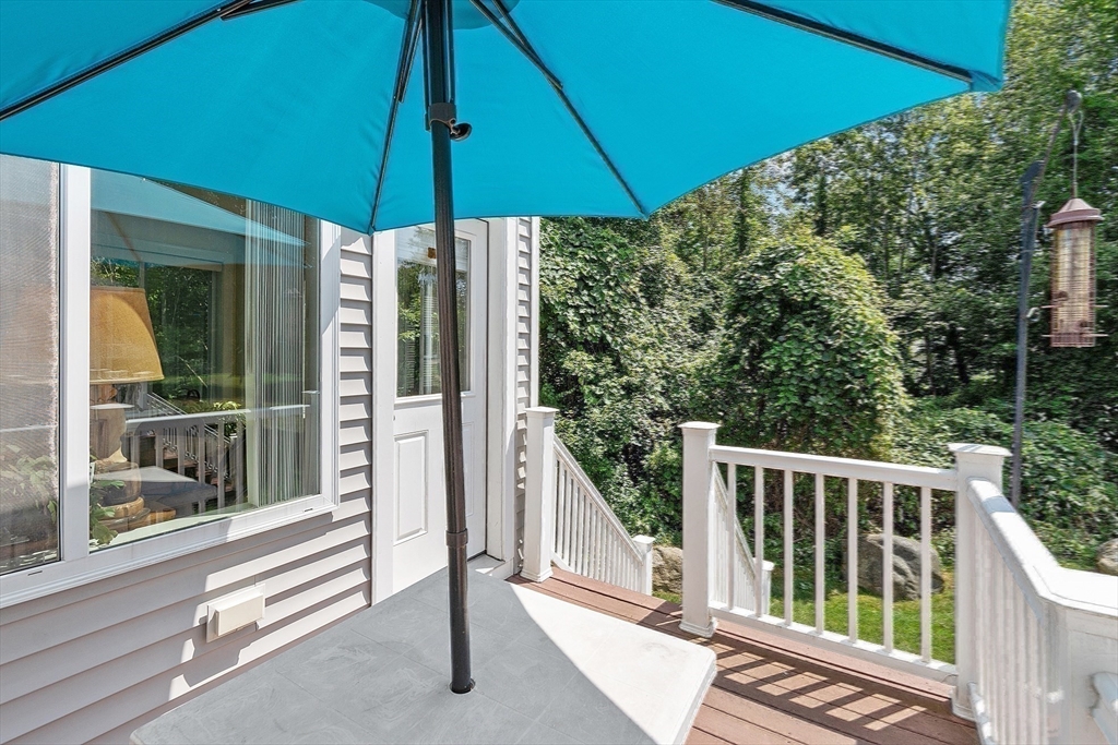 19 Marble Farm Road, Unit 19 Maynard, MA 01754 - Photo 15 of 42 a view of a balcony with chairs and an umbrella