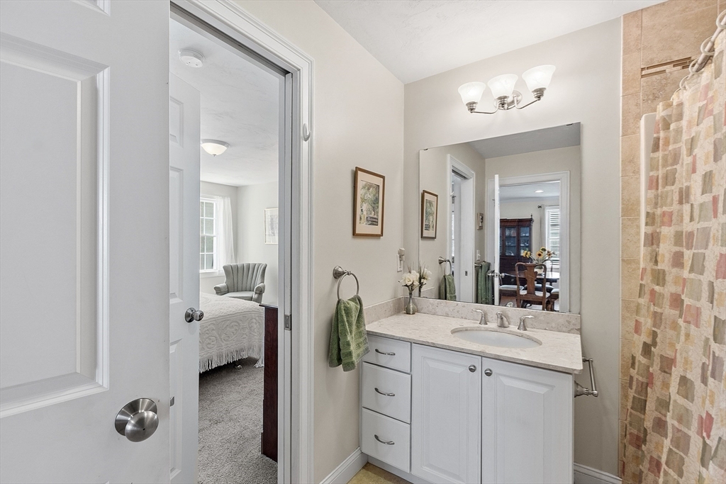 19 Marble Farm Road, Unit 19 Maynard, MA 01754 - Photo 18 of 42 a en suite bathroom with a double vanity sink a mirror and a shower