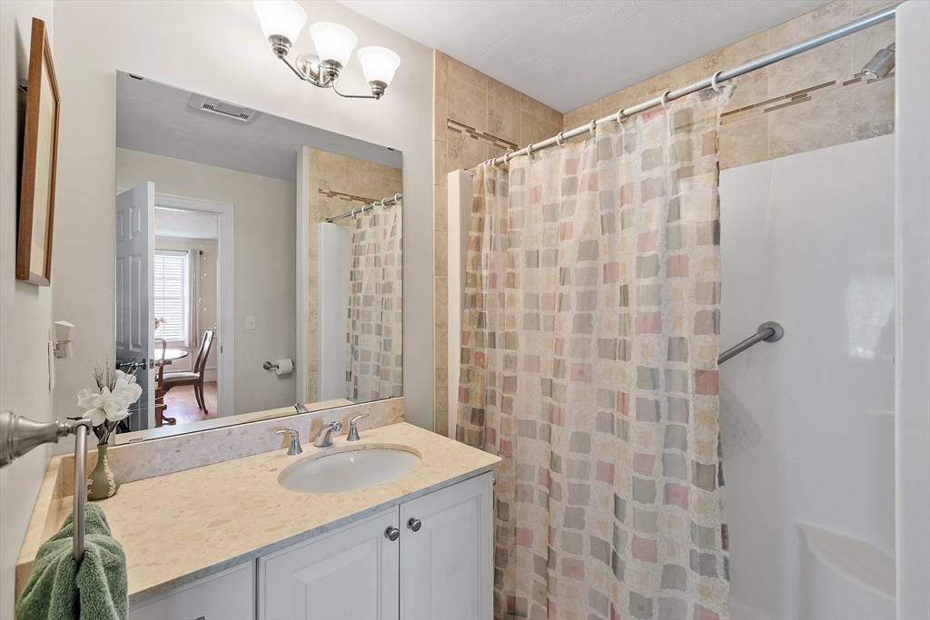 19 Marble Farm Road, Unit 19 Maynard, MA 01754 - Photo 19 of 42 a bathroom with a sink double vanity and a mirror