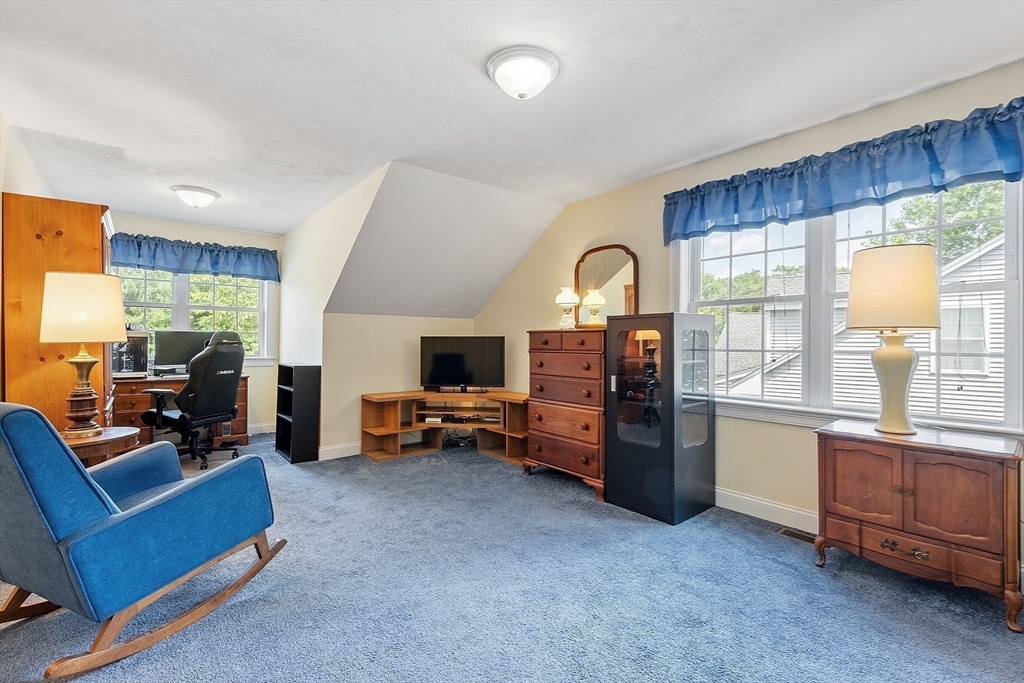 19 Marble Farm Road, Unit 19 Maynard, MA 01754 - Photo 22 of 42 a living room with furniture and a flat screen tv