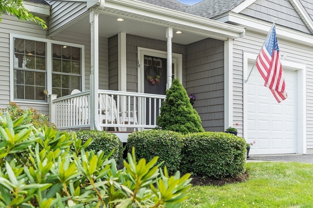19 Marble Farm Road, Unit 19 Maynard, MA 01754 - Photo 35 of 42 a view of a house with a small yard and flower plants