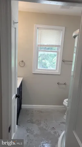 a view of room with window and hardwood