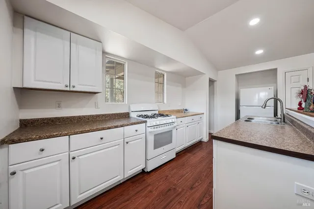 a kitchen with granite countertop white cabinets and a granite counter tops