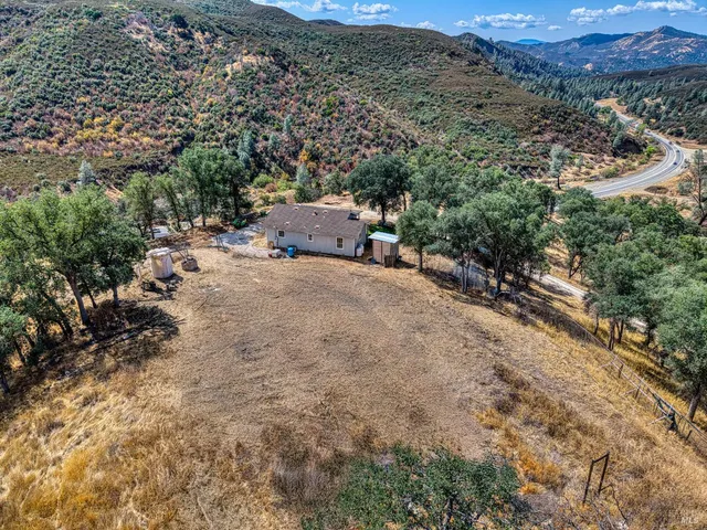 an aerial view of a house with a yard