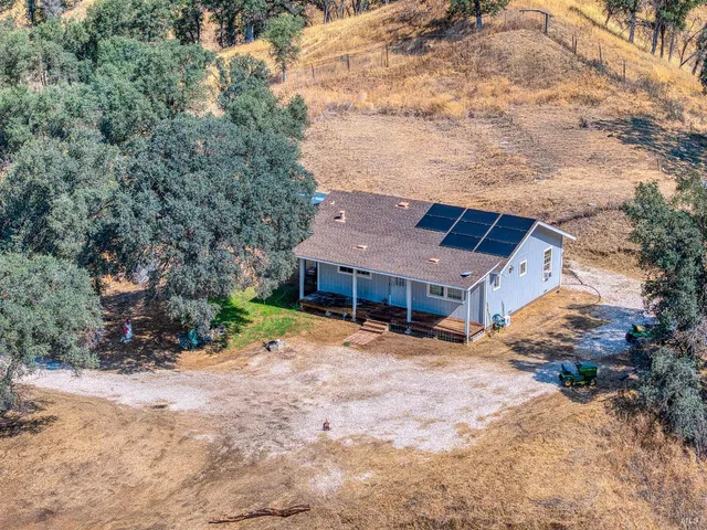 a tall house with a large tree in front of it