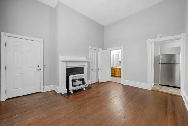 a view of a livingroom with a fireplace and wooden floor