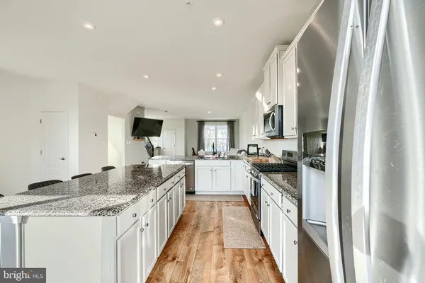 a kitchen with granite countertop a stove and a sink