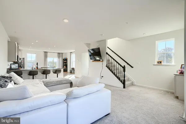 a living room with furniture and stairs