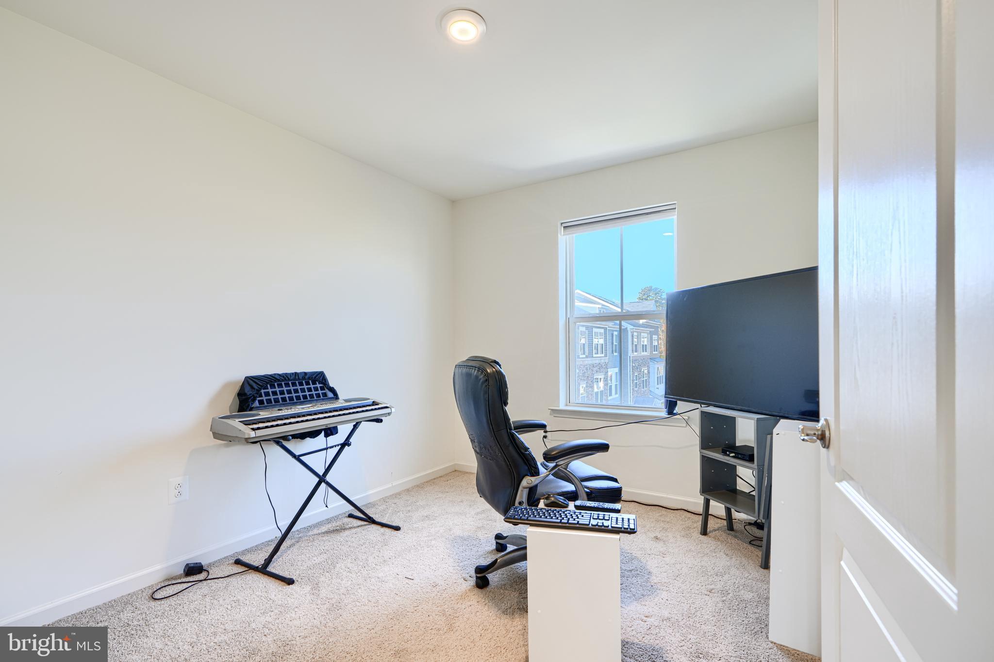 7141 Millstone Road Hanover, MD 21076 - Photo 19 of 32 a work room with furniture and a flat screen tv