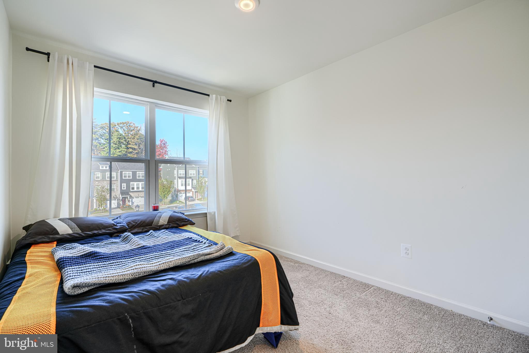 7141 Millstone Road Hanover, MD 21076 - Photo 21 of 32 a bedroom with a bed and a window