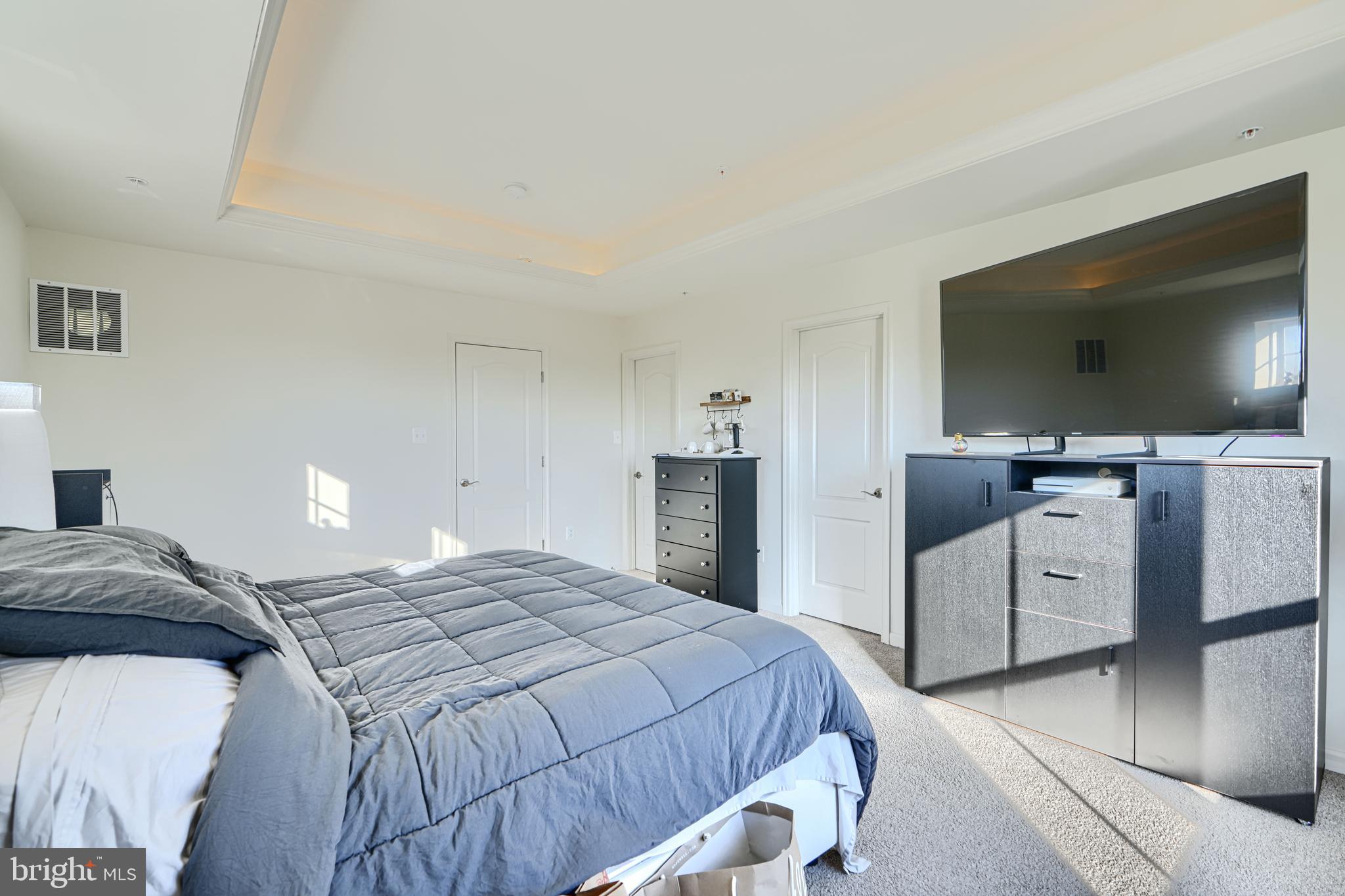 7141 Millstone Road Hanover, MD 21076 - Photo 25 of 32 a bedroom with a bed and a flat screen tv