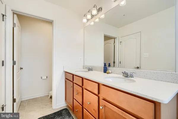 a bathroom with a sink double vanity and a mirror