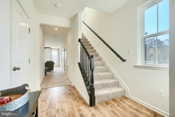 a view of entryway and hall with wooden floor