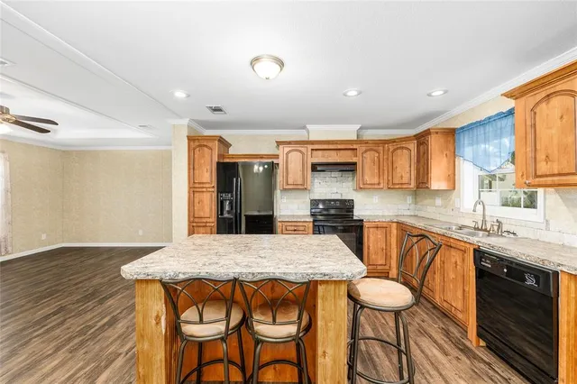 a view of an entryway with wooden floor and a livingroom view