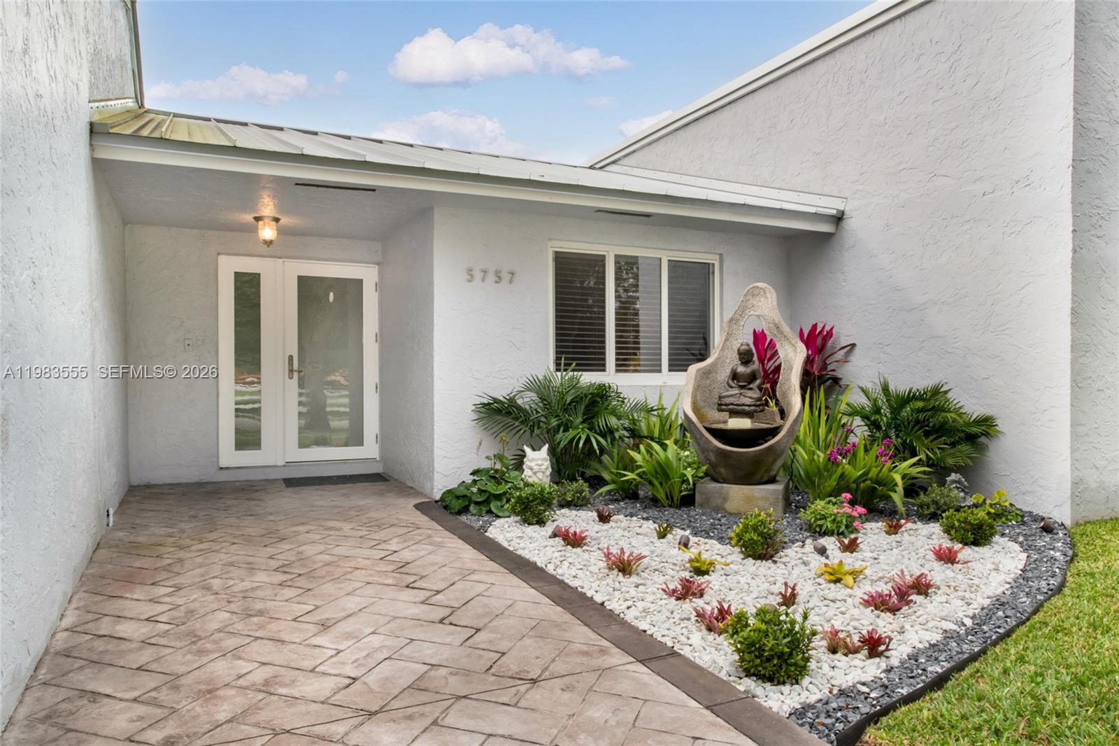 5757 Southwest 113th Avenue Cooper City, FL 33330 - Photo 11 of 48 a front view of a house with garden