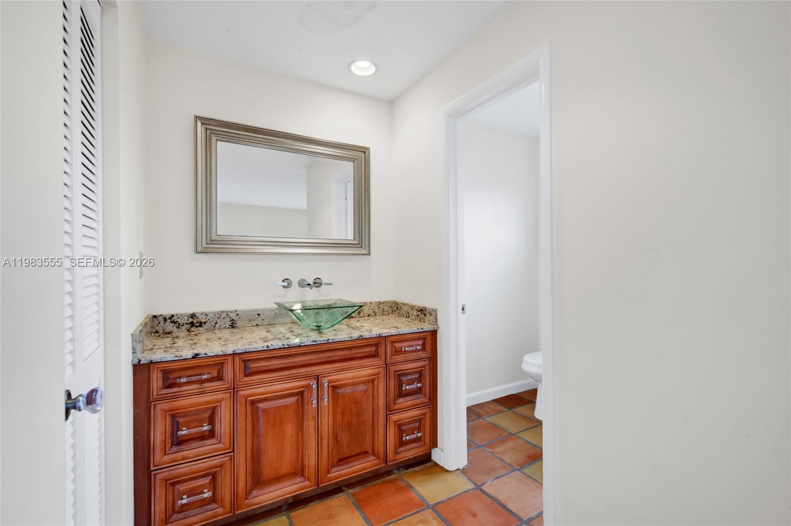 5757 Southwest 113th Avenue Cooper City, FL 33330 - Photo 24 of 48 a bathroom with a granite countertop sink and a mirror