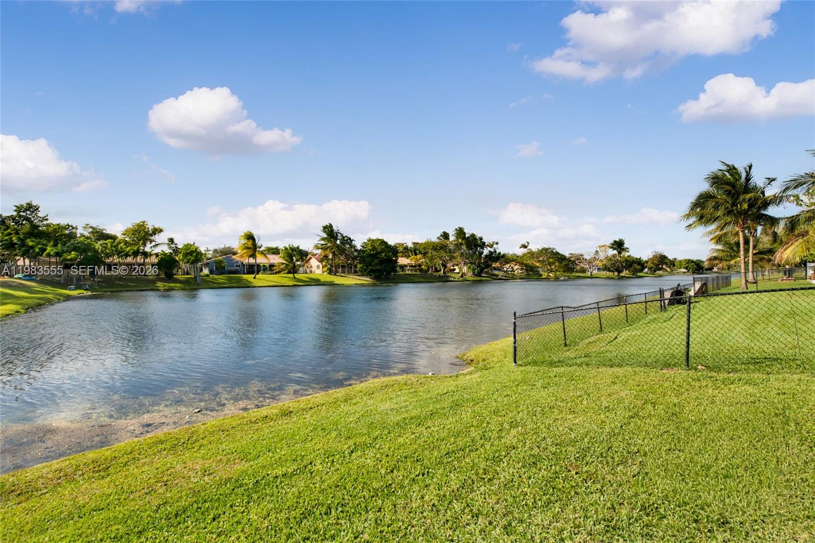 5757 Southwest 113th Avenue Cooper City, FL 33330 - Photo 34 of 48 a view of a lake with houses in the back