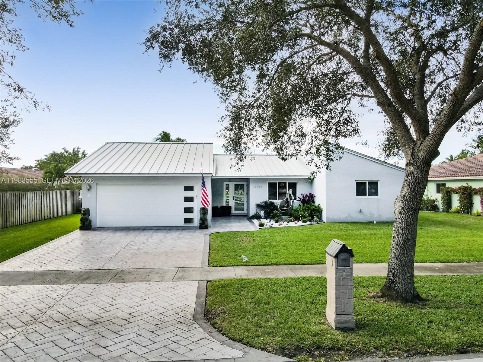5757 Southwest 113th Avenue Cooper City, FL 33330 - Photo 39 of 48 a front view of a house with a yard and garage