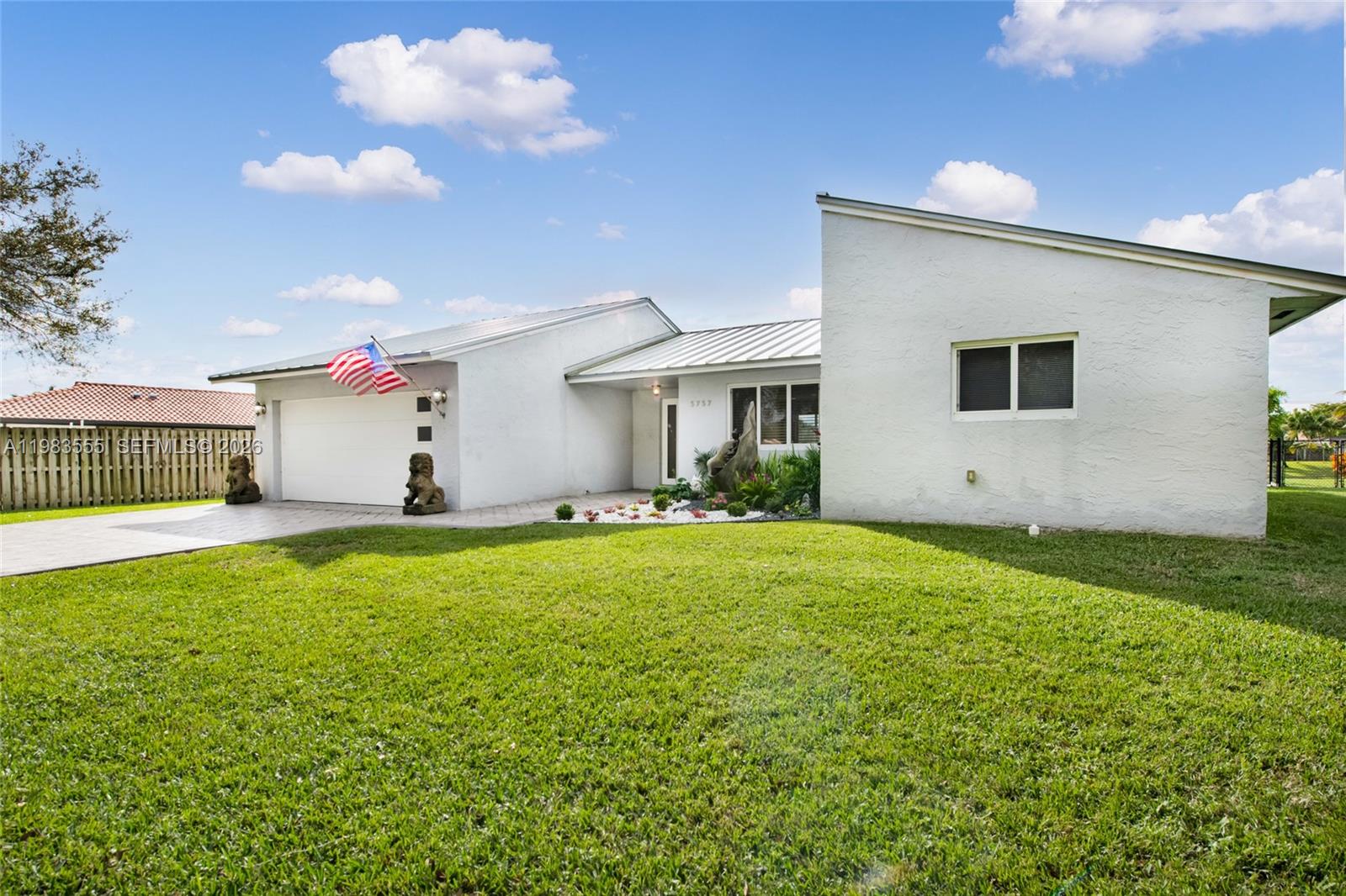 5757 Southwest 113th Avenue Cooper City, FL 33330 - Photo 7 of 48 a front view of house with yard and outdoor seating