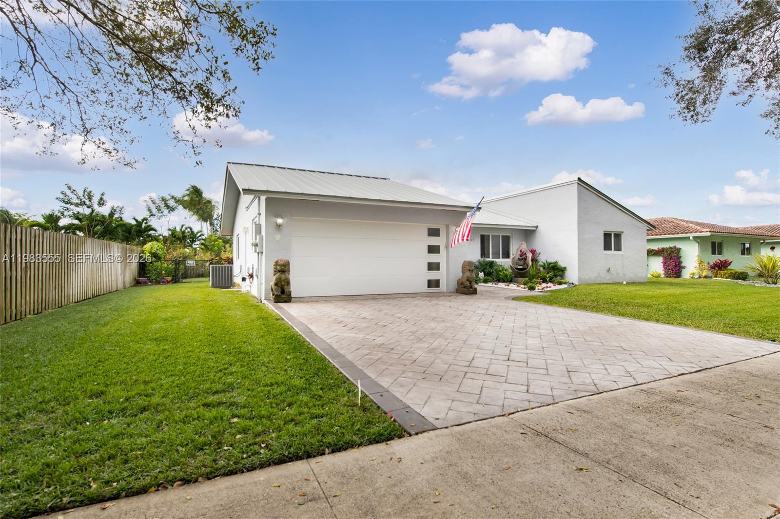 5757 Southwest 113th Avenue Cooper City, FL 33330 - Photo 9 of 48 a view of a white house with a big yard and large tree