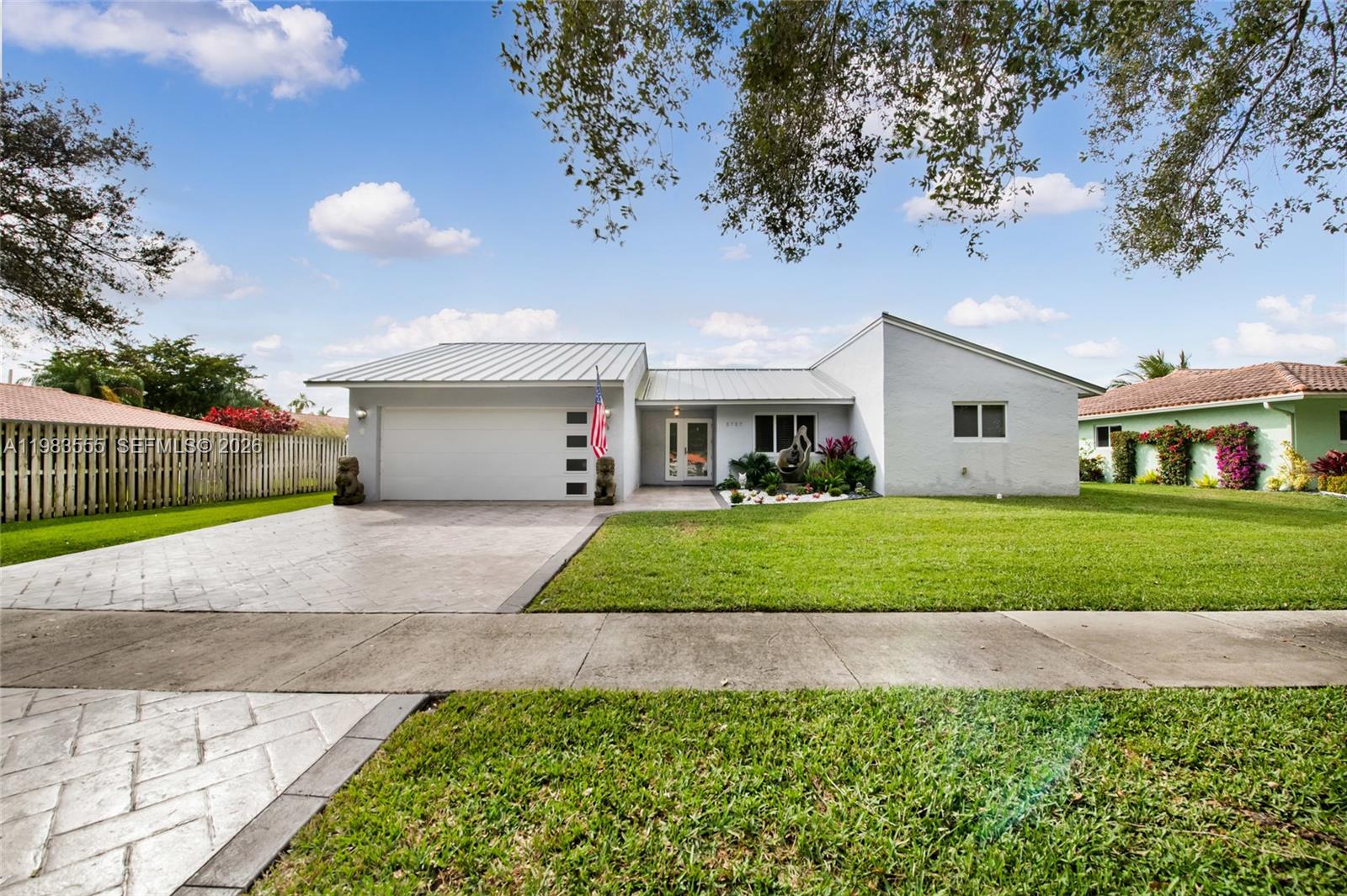 5757 Southwest 113th Avenue Cooper City, FL 33330 - Photo 10 of 48 a front view of a house with a yard and garage