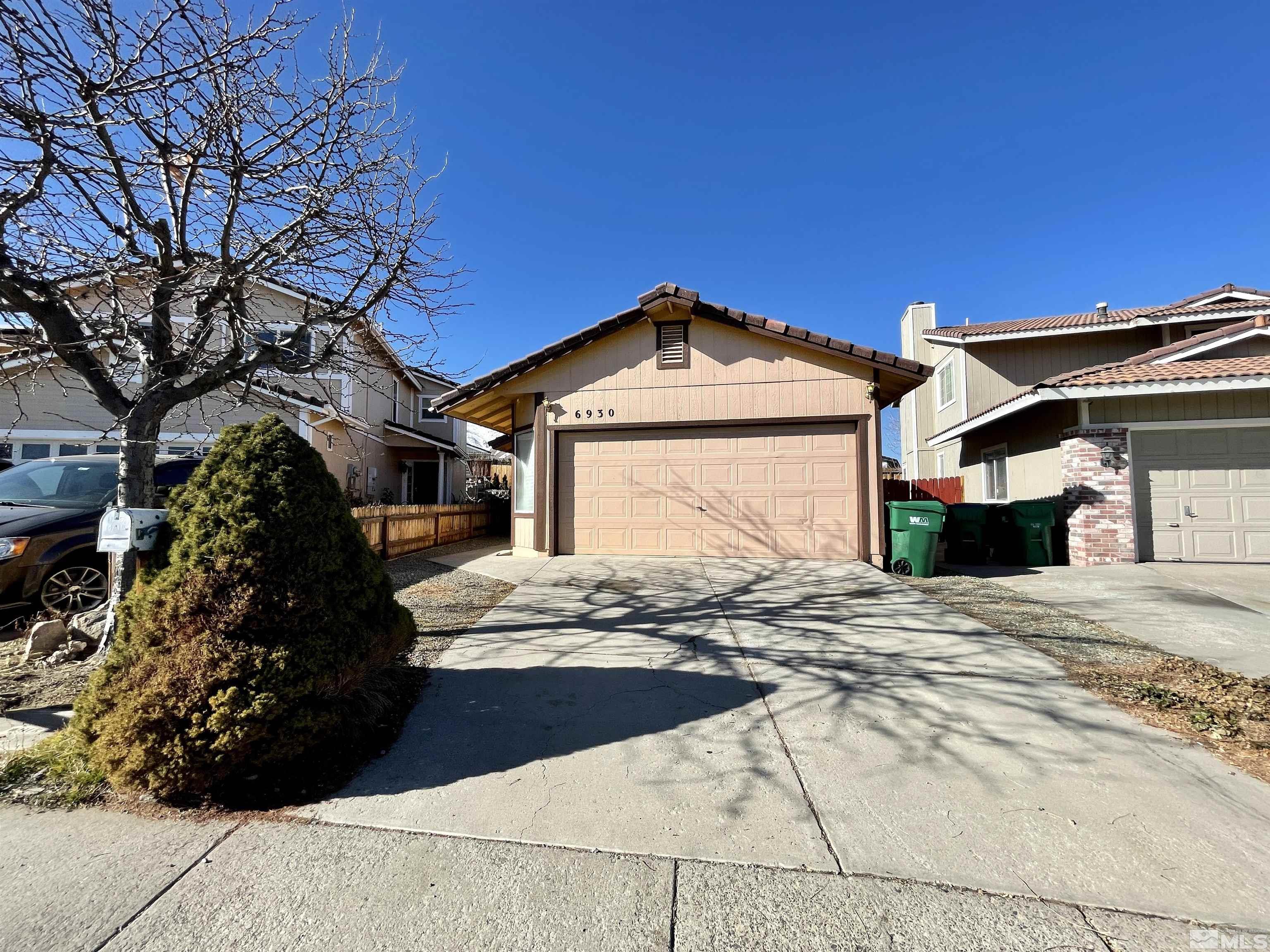 6930 Flower Street Reno, NV 89506 - Photo 1 of 19 a front view of a house with a pathway