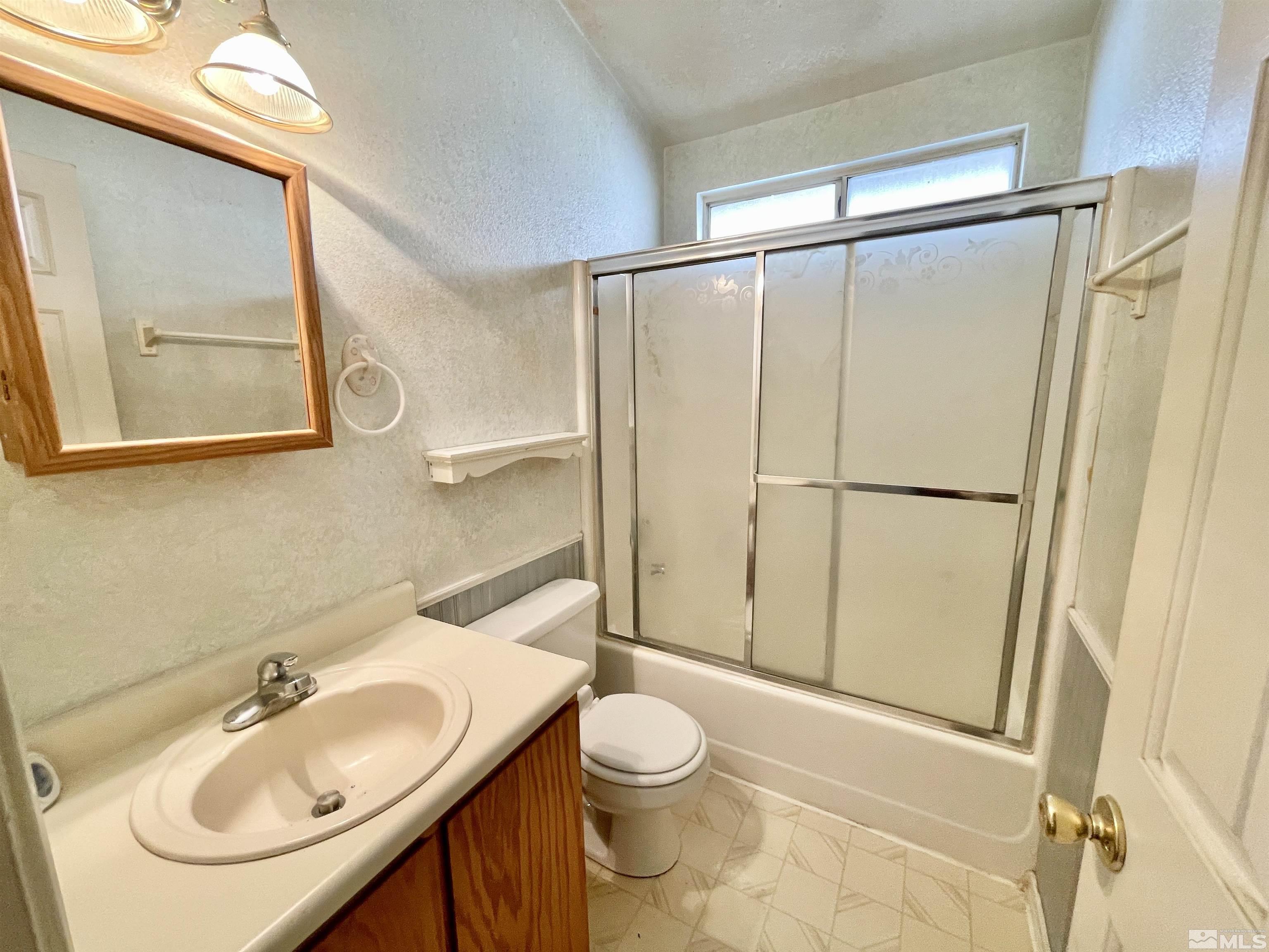 6930 Flower Street Reno, NV 89506 - Photo 13 of 19 a bathroom with a sink toilet and shower