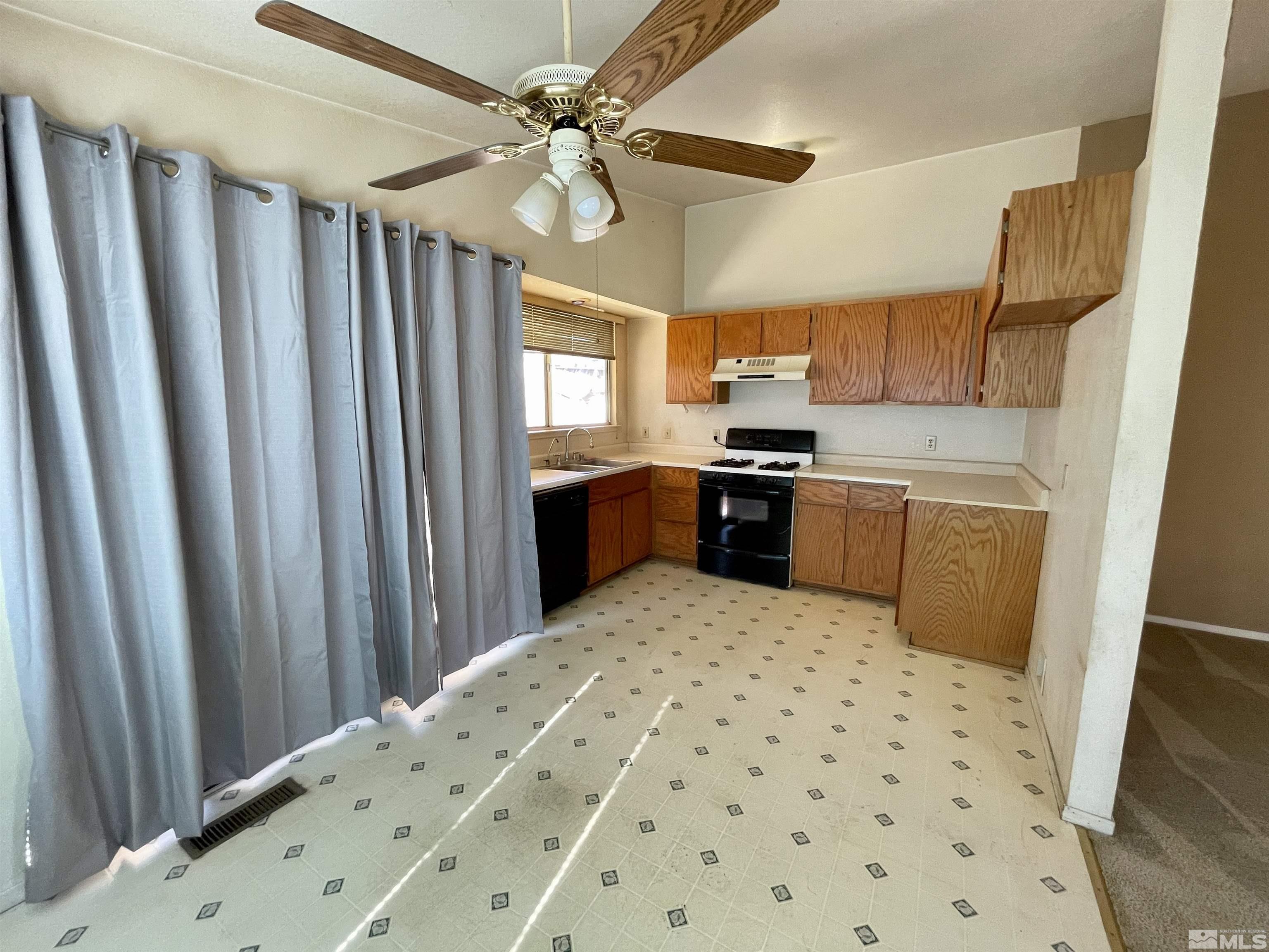 6930 Flower Street Reno, NV 89506 - Photo 5 of 19 a kitchen with a sink a stove top oven a sink and a refrigerator